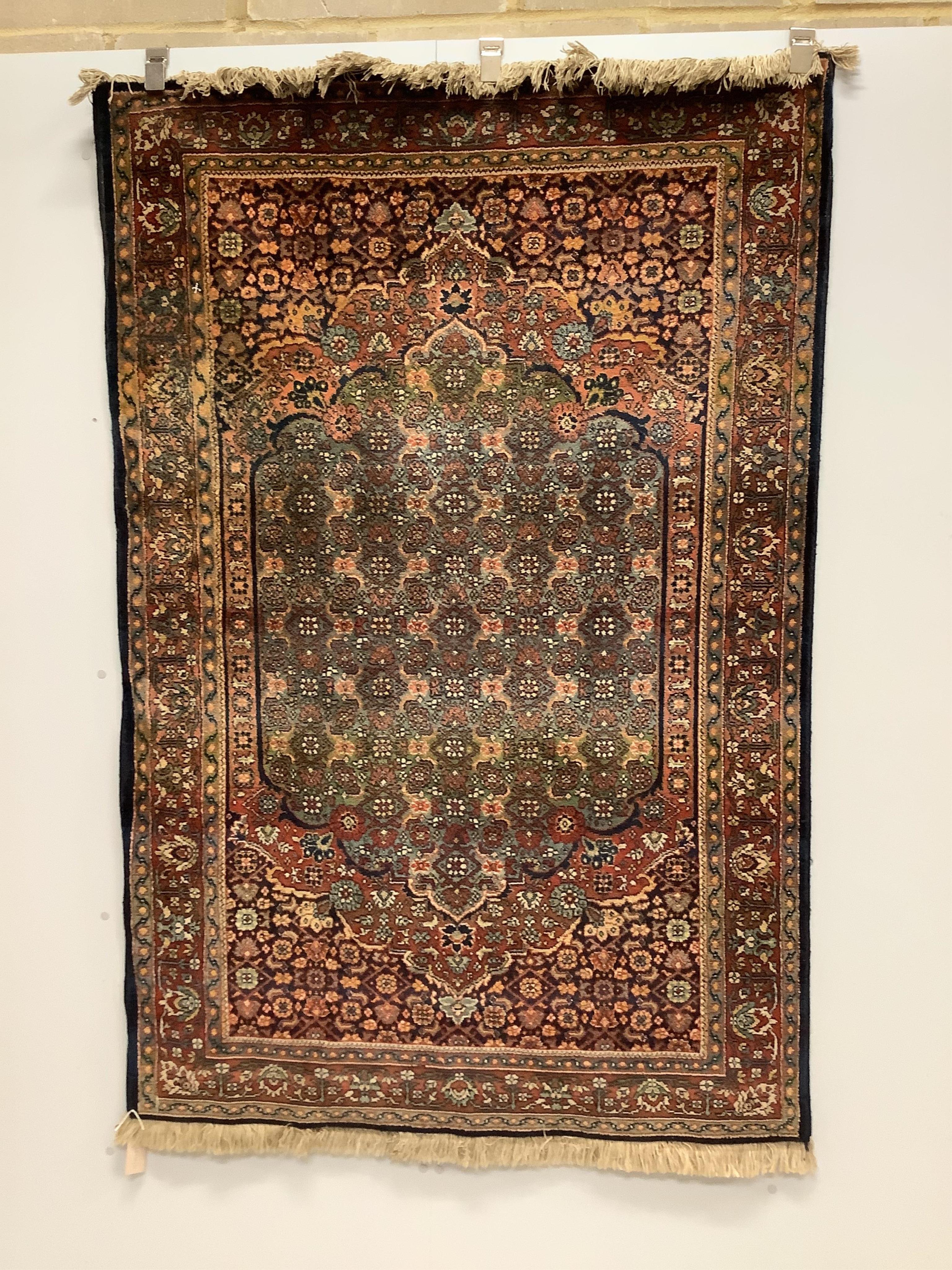 A Persian red and blue ground rug, 178 x 120cm. Condition - fair